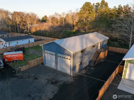 a view of a house with a yard and a garage