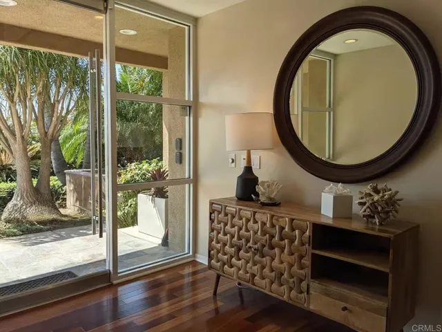 a view of entryway and hall with wooden floor