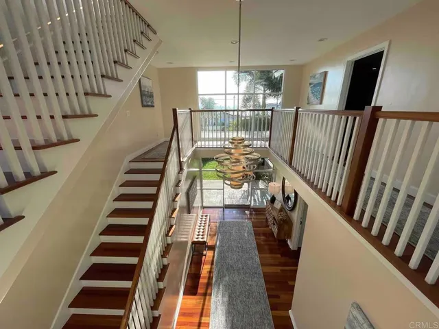 a living room with furniture and large windows