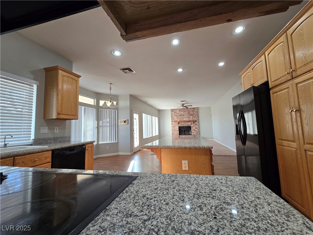 Undisclosed Address Las Vegas, NV 89149 - Photo 11 of 34 Kitchen with recessed lighting, pendant lighting, dark wood finished floors, black appliances, and a center island