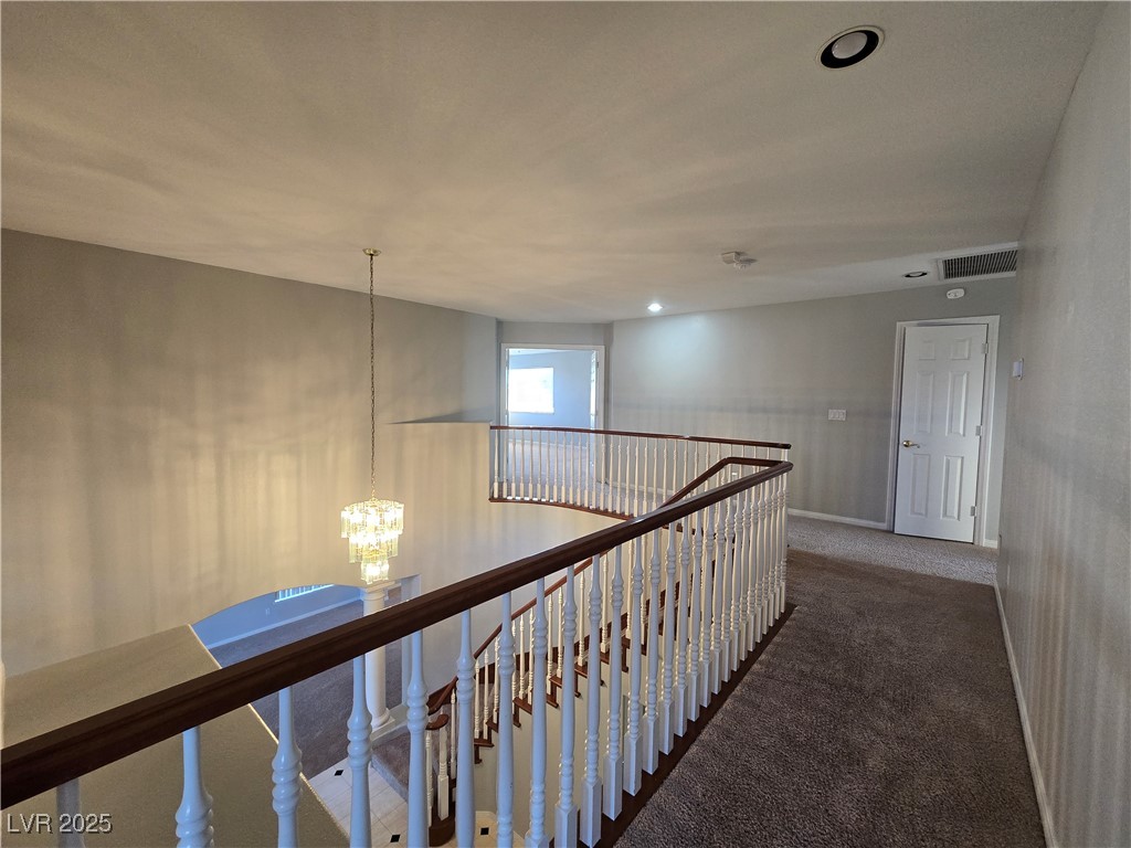 Undisclosed Address Las Vegas, NV 89149 - Photo 15 of 34 Hall featuring dark carpet, a chandelier, an upstairs landing, and recessed lighting