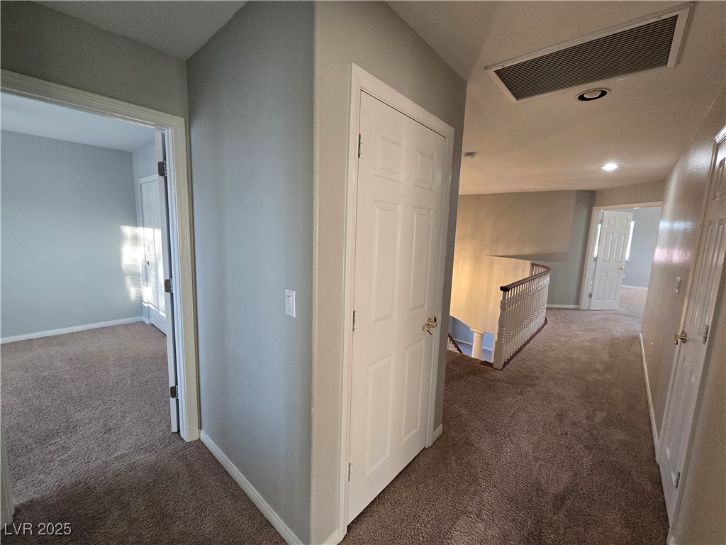 Undisclosed Address Las Vegas, NV 89149 - Photo 16 of 34 Hall with dark carpet, an upstairs landing, and recessed lighting