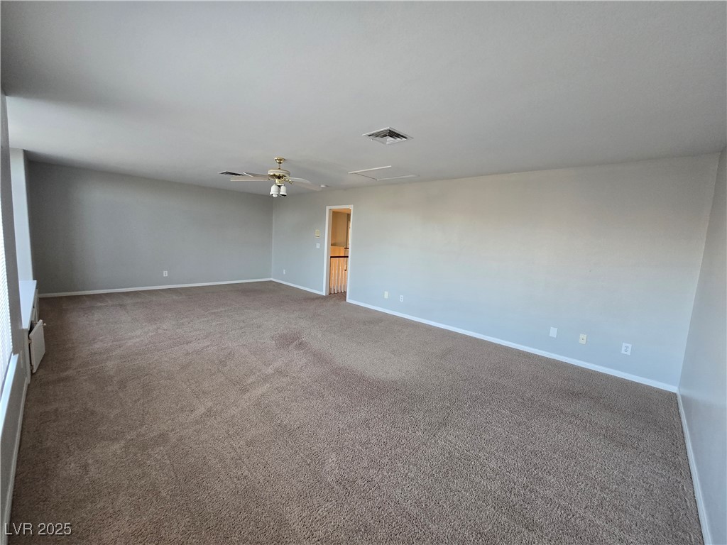 Undisclosed Address Las Vegas, NV 89149 - Photo 18 of 34 Carpeted empty room with ceiling fan and attic access