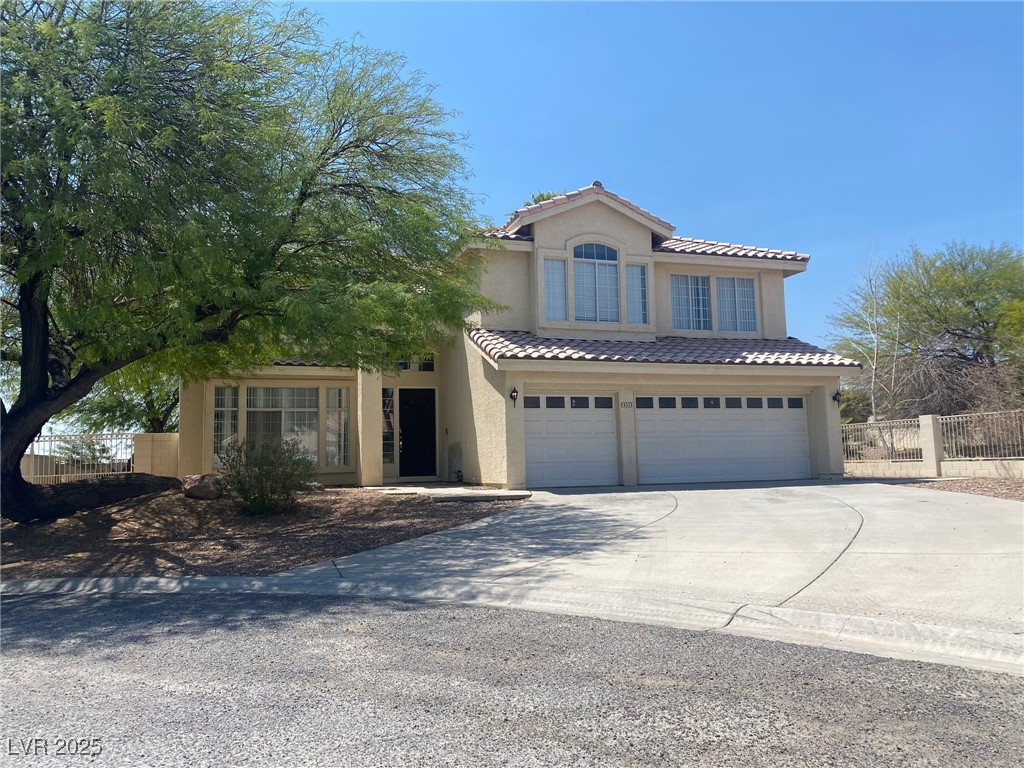 Undisclosed Address Las Vegas, NV 89149 - Photo 2 of 34 View of front of house featuring concrete driveway, an attached garage, stucco siding, and a tile roof