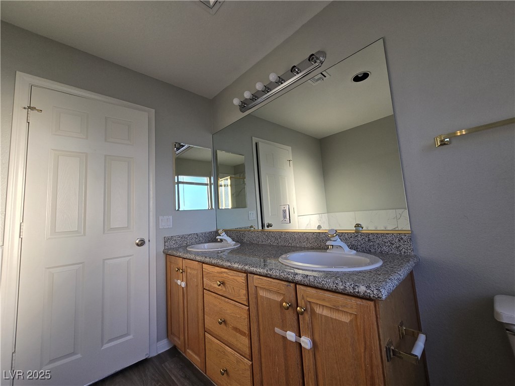 Undisclosed Address Las Vegas, NV 89149 - Photo 23 of 34 Full bath with double vanity and dark wood-style floors