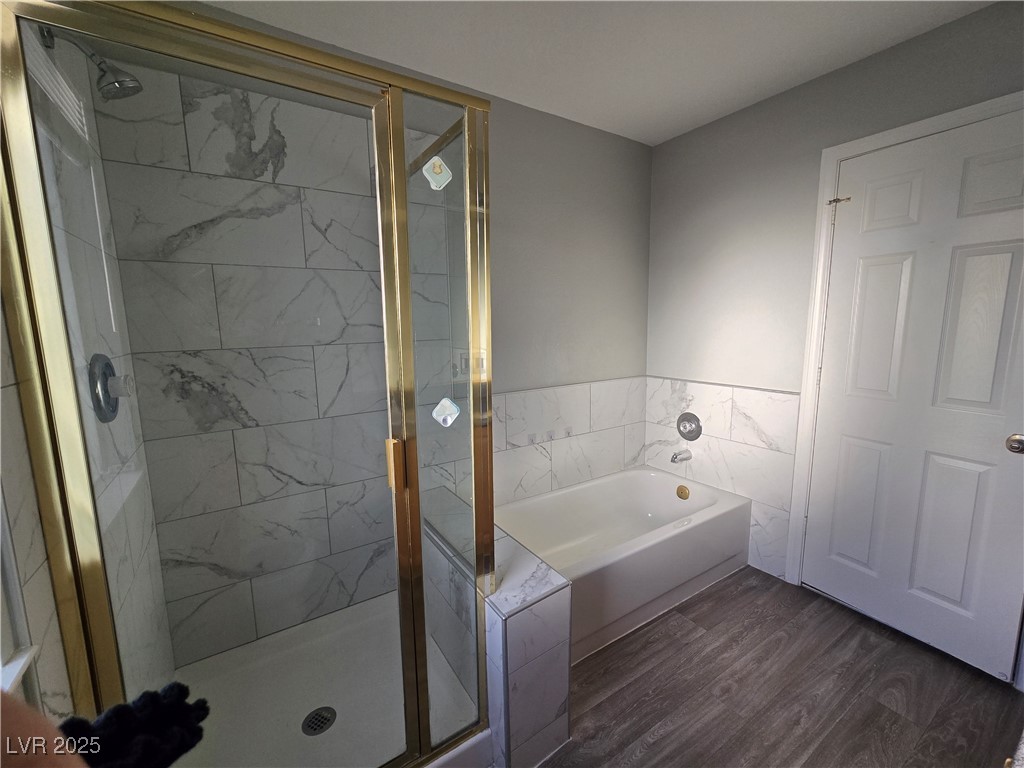 Undisclosed Address Las Vegas, NV 89149 - Photo 24 of 34 Full bath with dark wood finished floors, a garden tub, and a stall shower