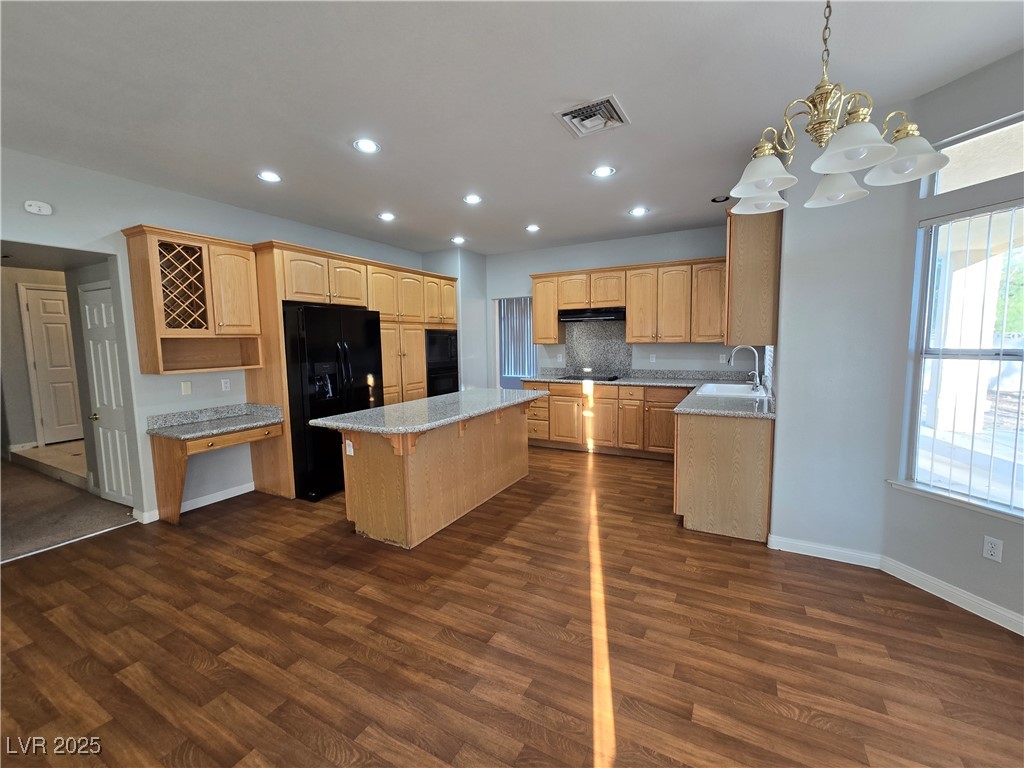 Undisclosed Address Las Vegas, NV 89149 - Photo 10 of 34 Kitchen with a center island, pendant lighting, a kitchen bar, a chandelier, and black appliances