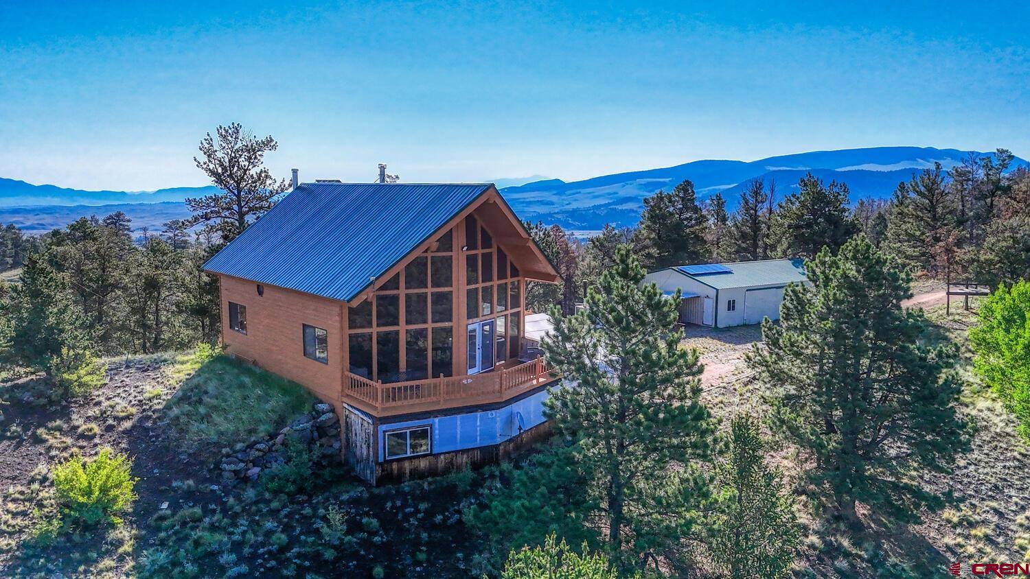 a view of a house with a yard and sitting area