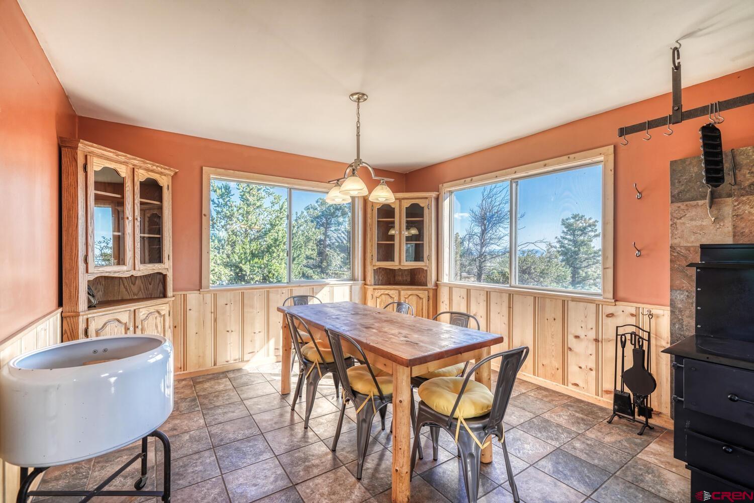 741 Wolfe Road Hartsel, CO 80449 - Photo 17 of 45 a dining room with furniture a chandelier and wooden floor
