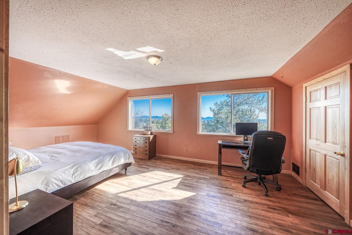 741 Wolfe Road Hartsel, CO 80449 - Photo 18 of 45 a bedroom with a bed and wooden floor