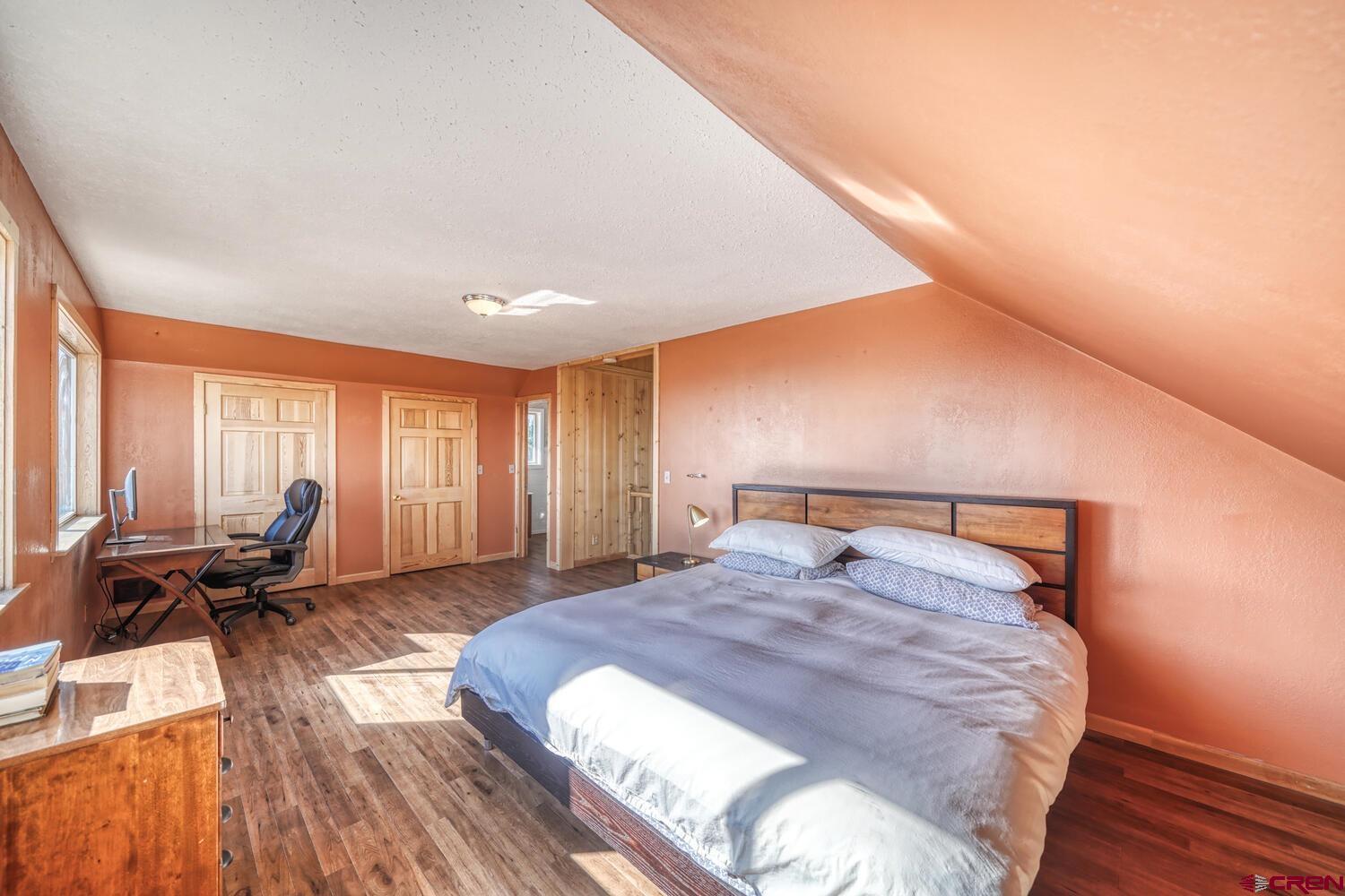 741 Wolfe Road Hartsel, CO 80449 - Photo 19 of 45 a bed sitting in a spacious bedroom next to a window