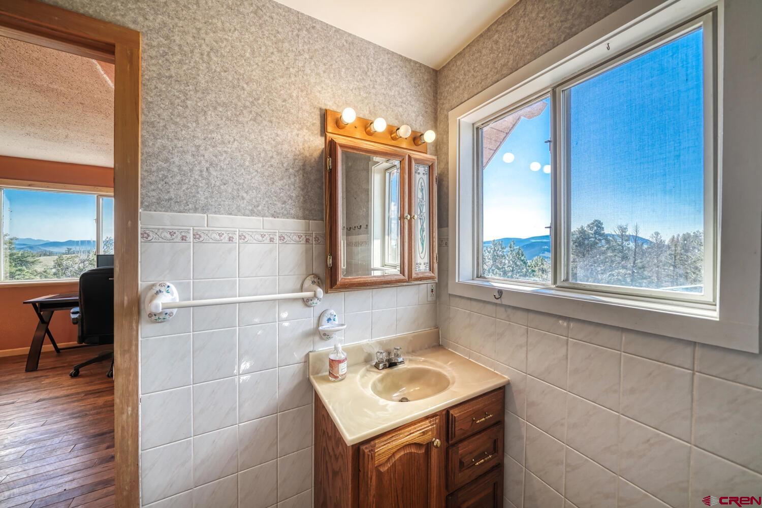 741 Wolfe Road Hartsel, CO 80449 - Photo 20 of 45 a bathroom with a sink and a mirror