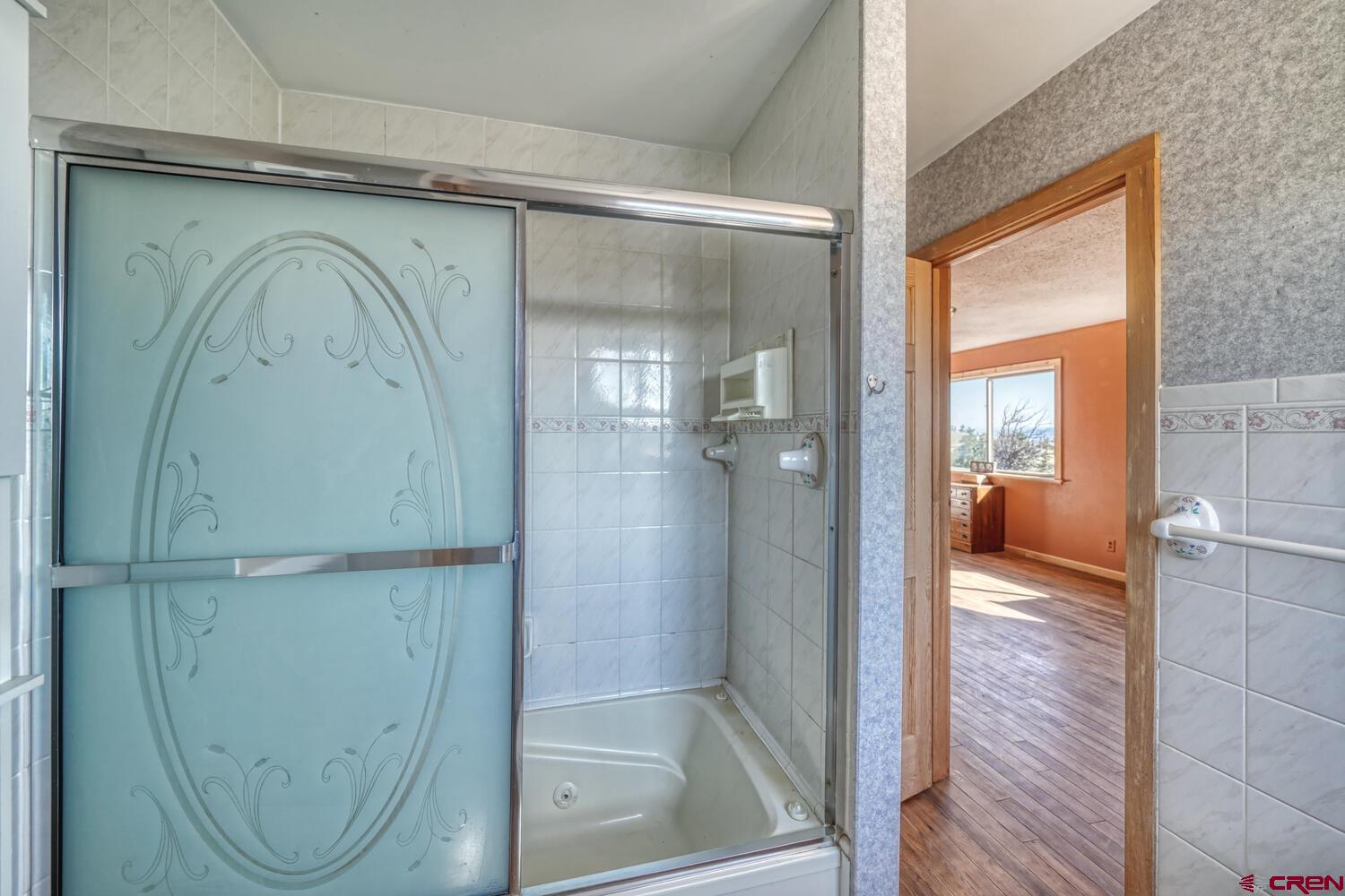 741 Wolfe Road Hartsel, CO 80449 - Photo 21 of 45 a bathroom with a glass shower door