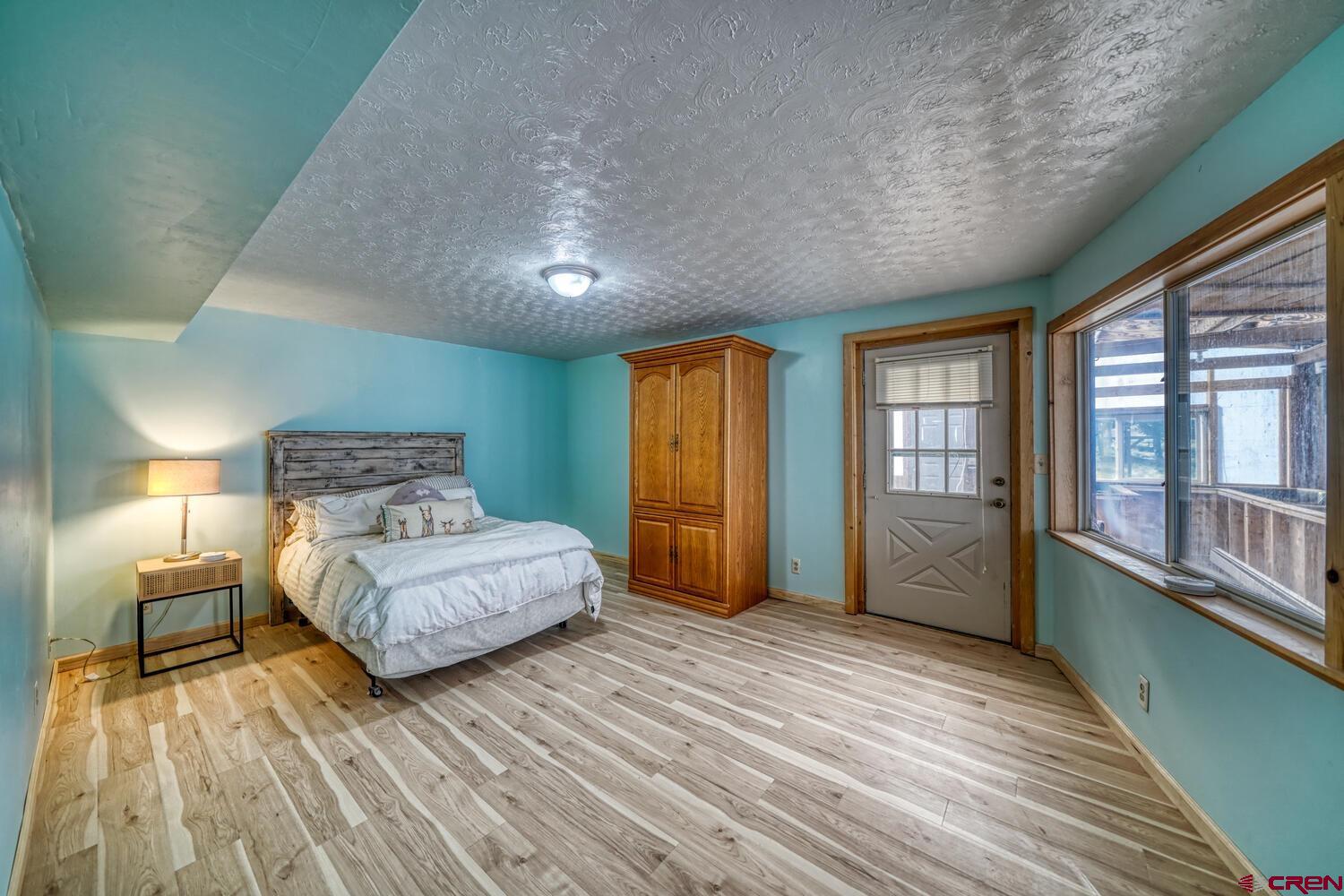 741 Wolfe Road Hartsel, CO 80449 - Photo 23 of 45 a spacious bedroom with a bed and large windows