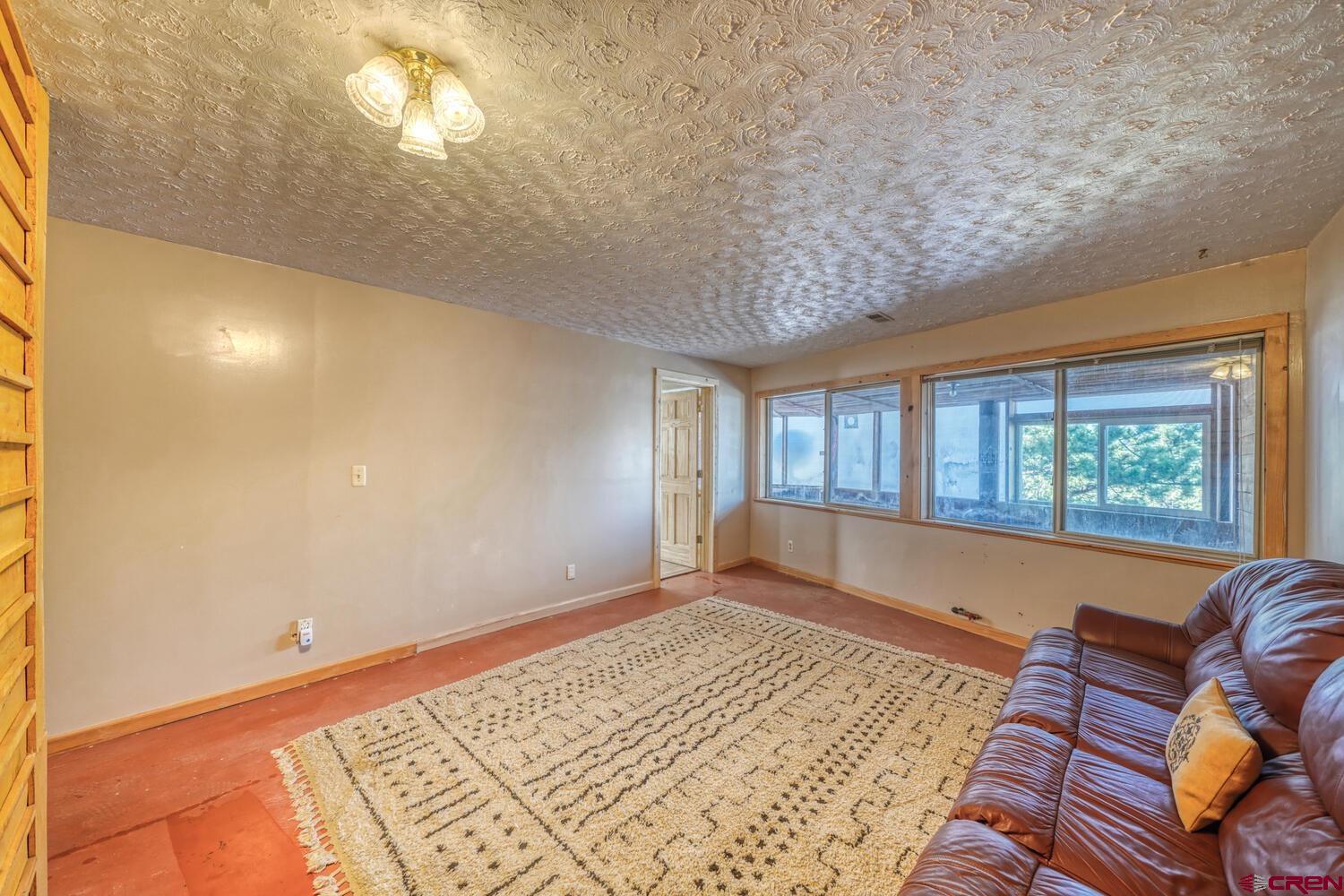 741 Wolfe Road Hartsel, CO 80449 - Photo 27 of 45 a living room with furniture and a window
