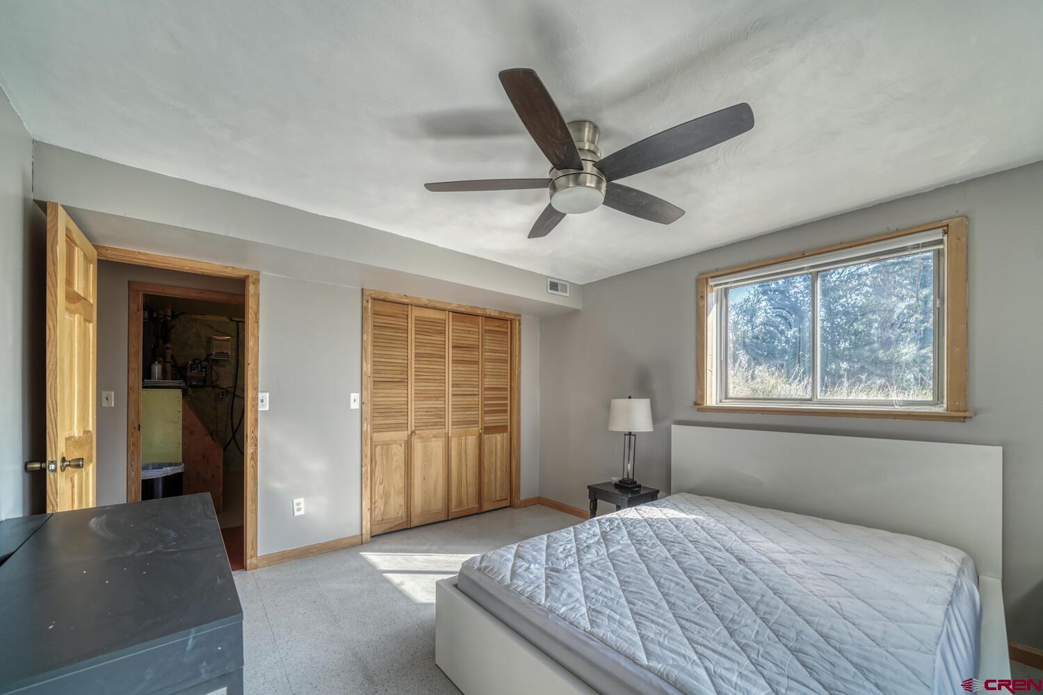 741 Wolfe Road Hartsel, CO 80449 - Photo 30 of 45 a bedroom with a large bed and a window