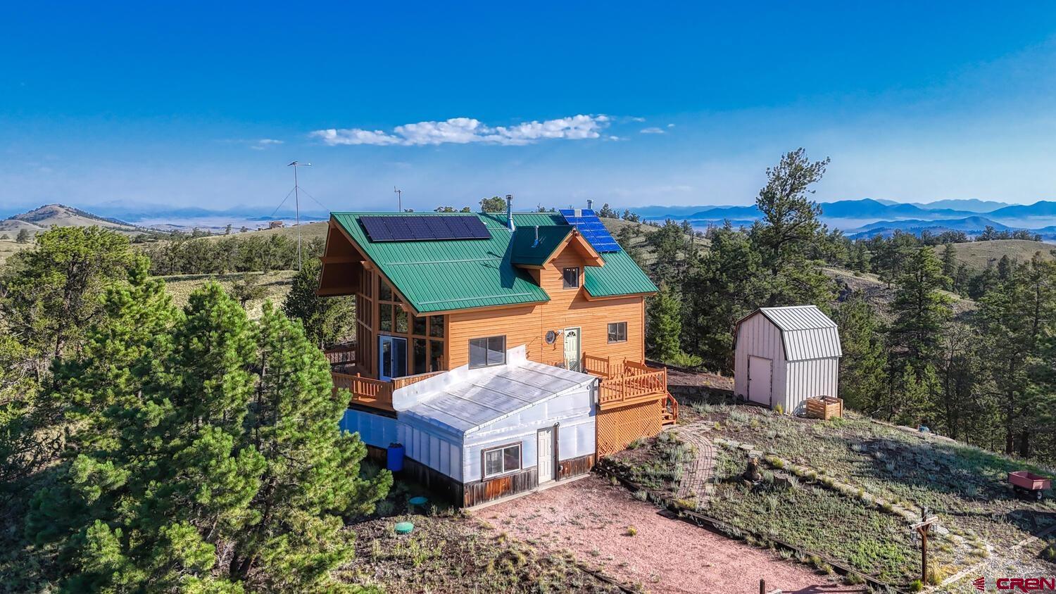 741 Wolfe Road Hartsel, CO 80449 - Photo 34 of 45 a view of a house with a yard and sitting area