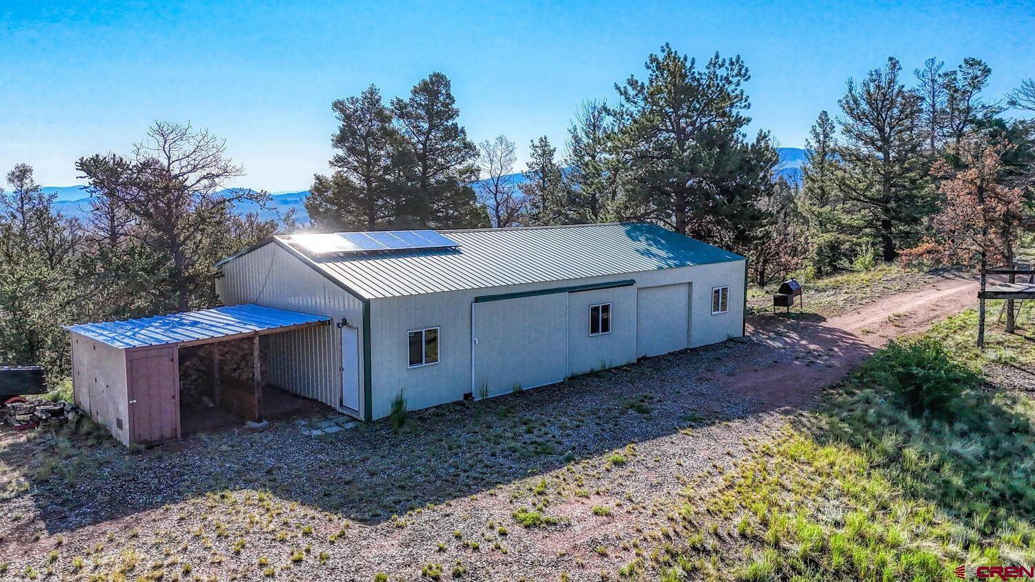 741 Wolfe Road Hartsel, CO 80449 - Photo 40 of 45 a view of a backyard with large trees and wooden fence