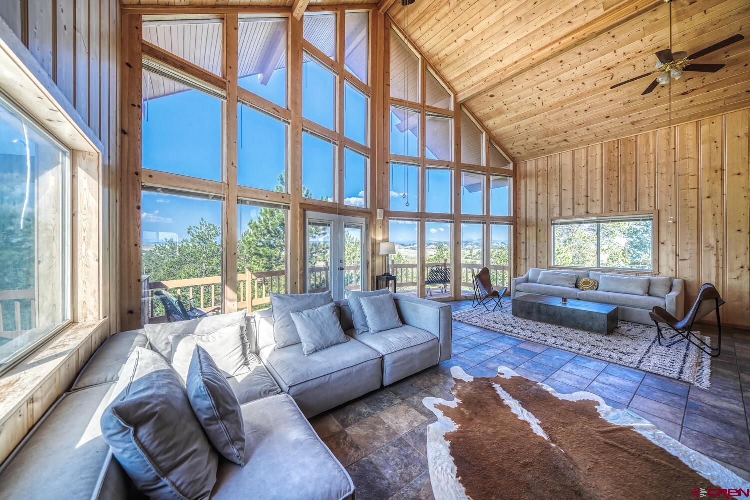 741 Wolfe Road Hartsel, CO 80449 - Photo 8 of 45 a living room with furniture large windows and wooden floor