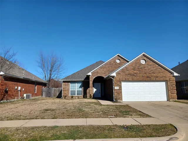 a view of a house with a yard and garage
