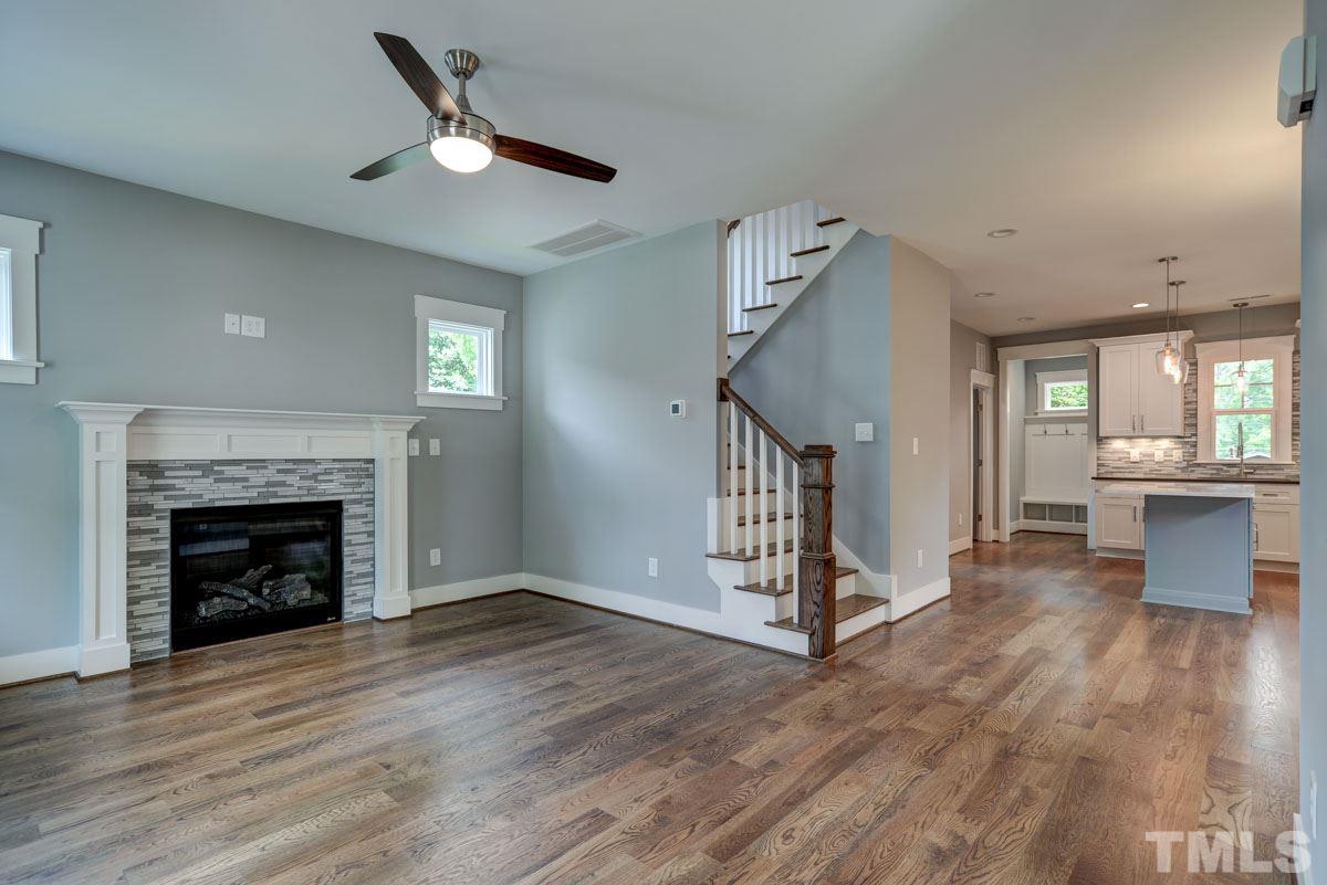 1416 East Jones Street Raleigh, NC 27610 - Photo 14 of 30 a view of a livingroom with wooden floor a fireplace