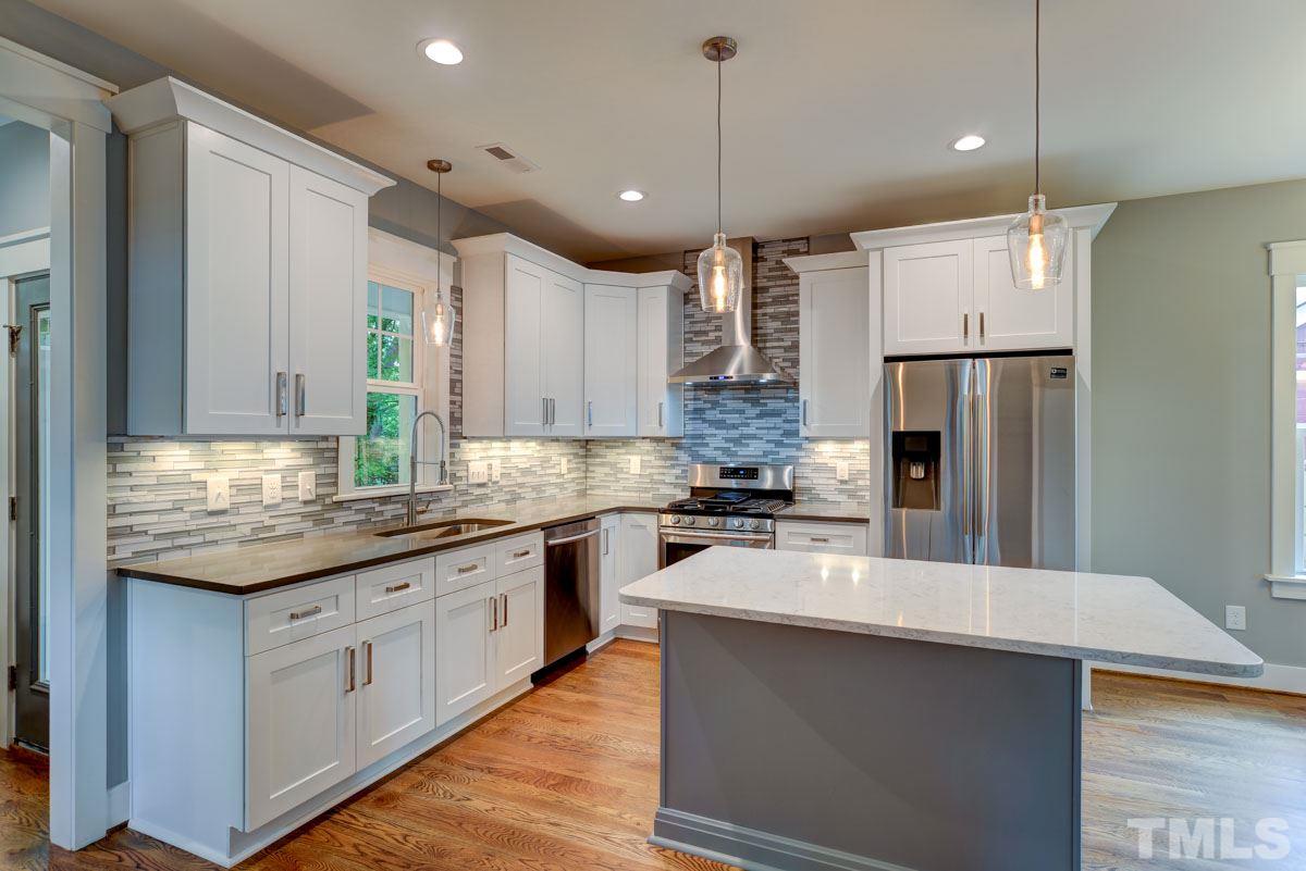 1416 East Jones Street Raleigh, NC 27610 - Photo 3 of 30 a open kitchen with stainless steel appliances granite countertop a refrigerator a sink dishwasher a oven and white cabinets with wooden floor
