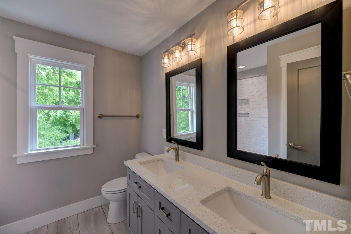 1416 East Jones Street Raleigh, NC 27610 - Photo 22 of 30 a bathroom with a sink a toilet a mirror and window