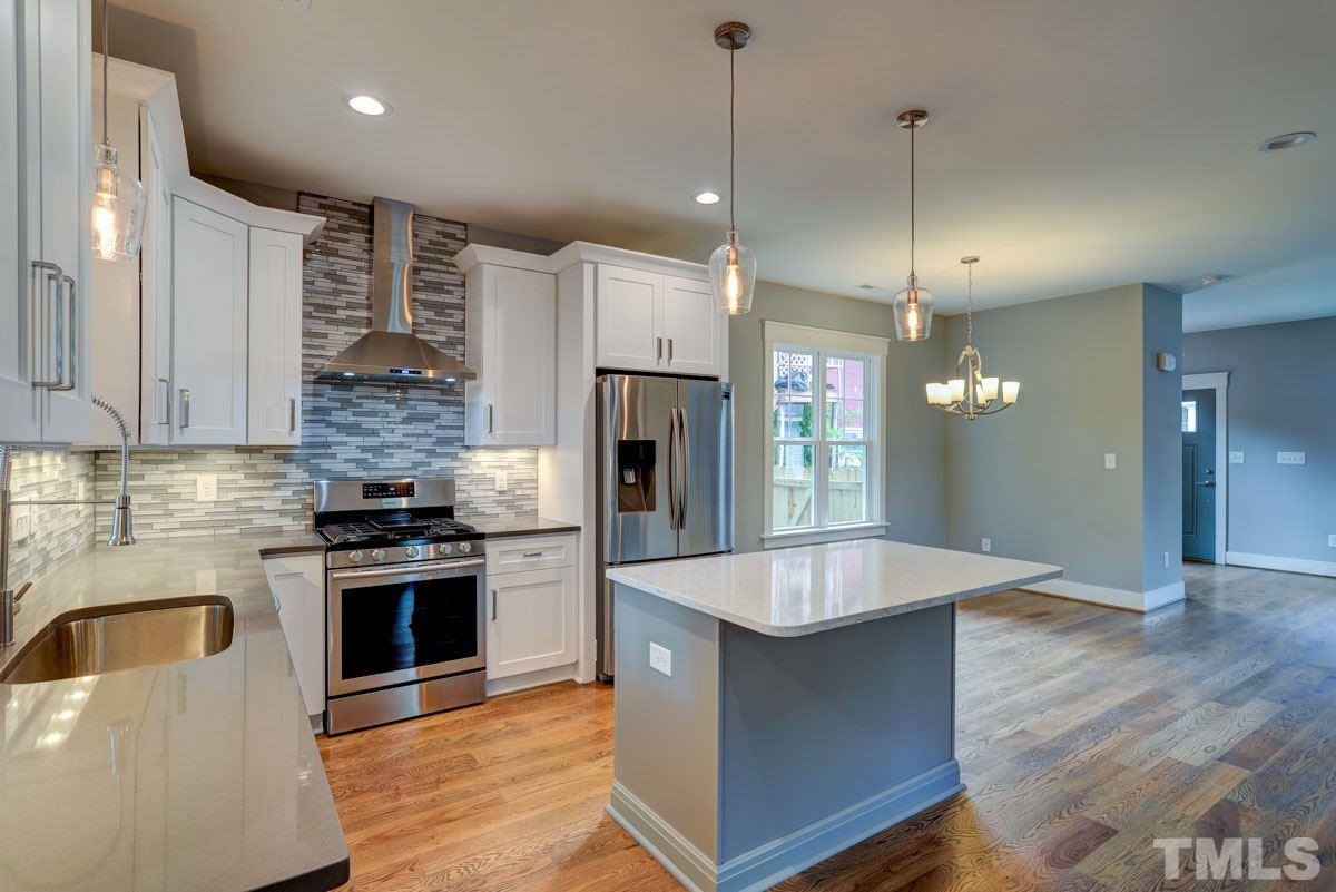 1416 East Jones Street Raleigh, NC 27610 - Photo 4 of 30 a large kitchen with granite countertop a stove and a sink