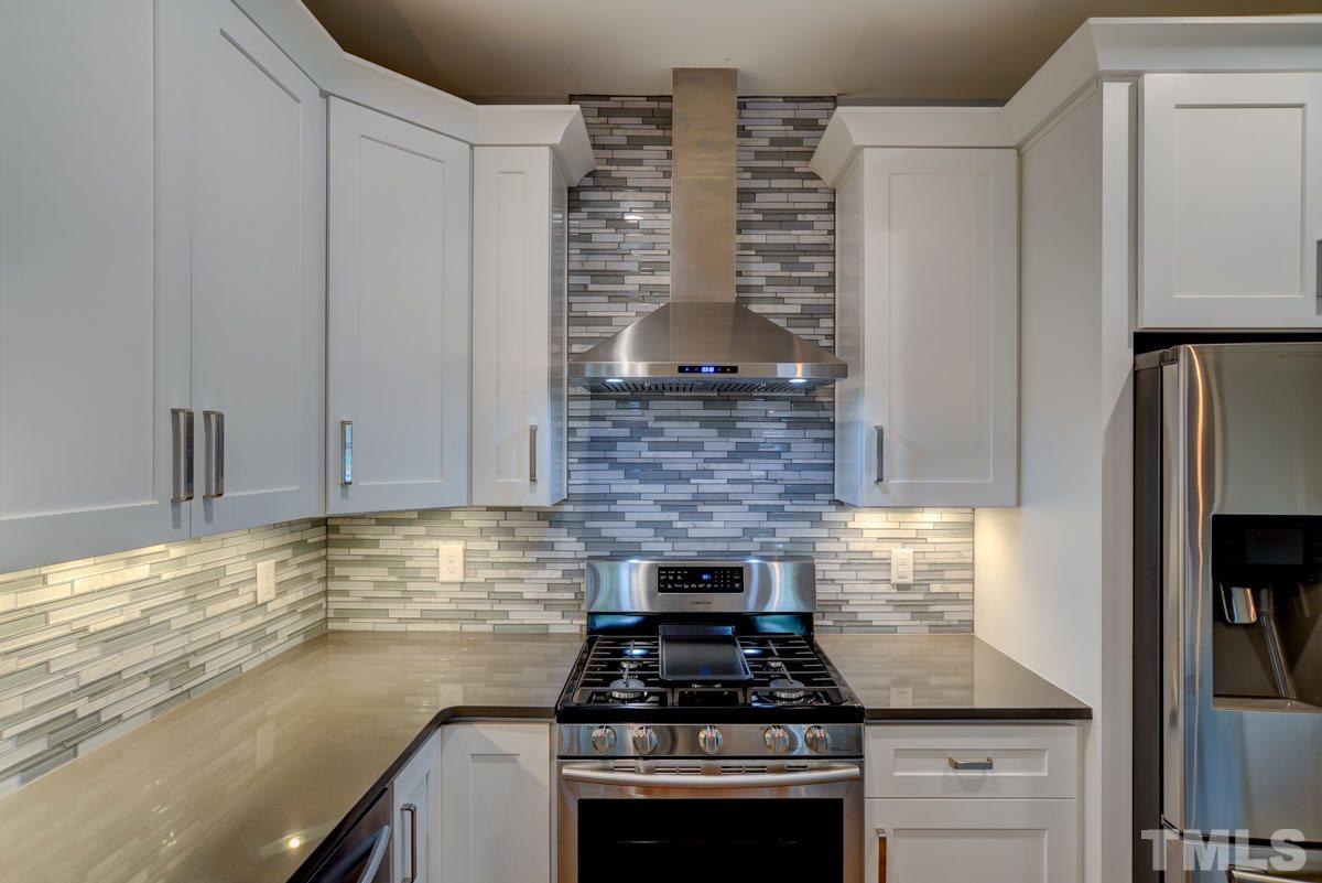1416 East Jones Street Raleigh, NC 27610 - Photo 6 of 30 a kitchen with granite countertop a stove and a refrigerator