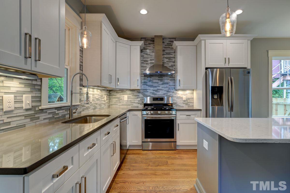 1416 East Jones Street Raleigh, NC 27610 - Photo 8 of 30 a modern kitchen with stainless steel appliances granite countertop a sink and a stove