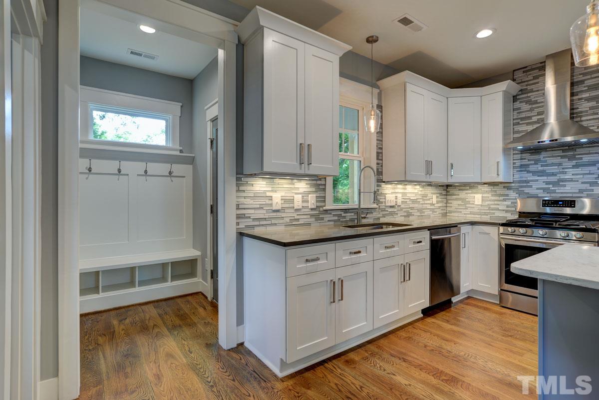 1416 East Jones Street Raleigh, NC 27610 - Photo 9 of 30 a kitchen with granite countertop a refrigerator and a stove top oven