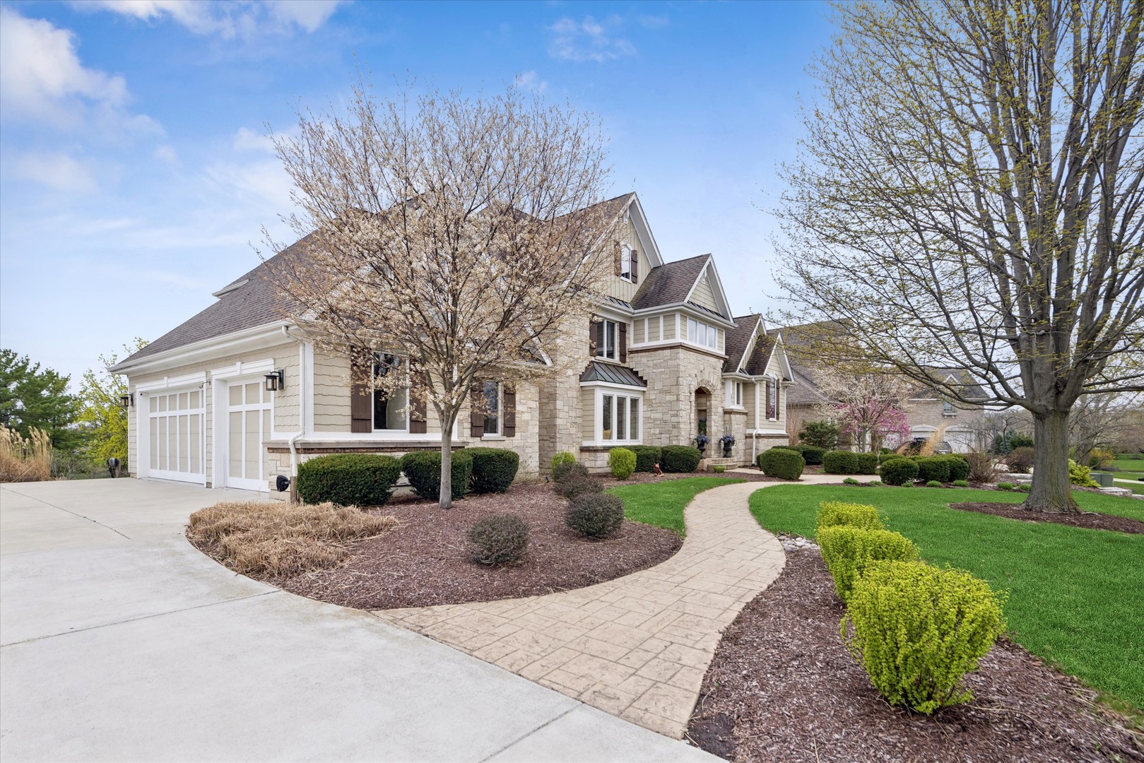 521 River Ridge Drive St. Charles, IL 60175 - Photo 2 of 46 a front view of a house with garden and trees