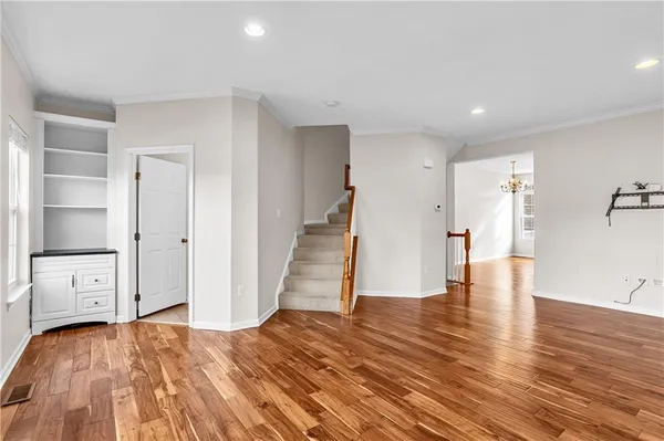 a view of an empty room and wooden floor