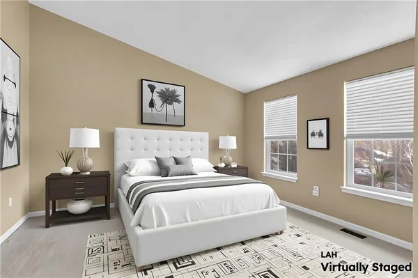 a bedroom with a bed and a lamp on dresser