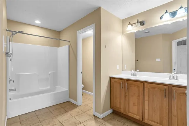a spacious bathroom with a glass shower door and a mirror