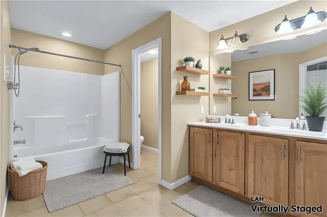 a bathroom with a tub sink and mirror