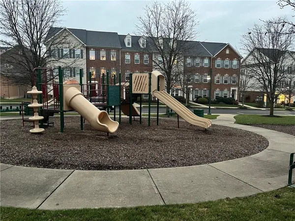 a backyard of a house with barbeque oven fire pit and chairs