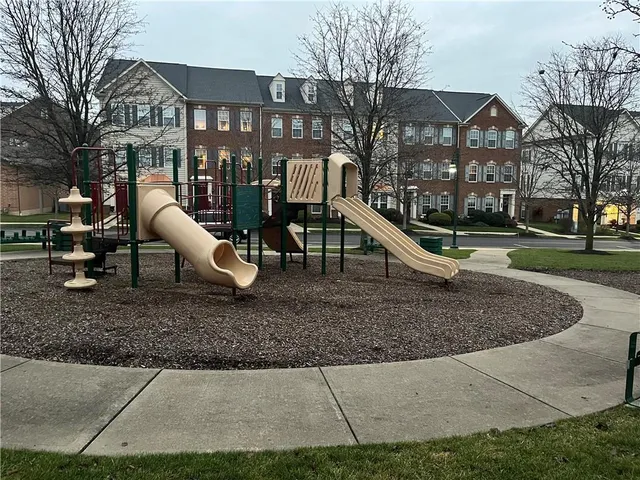 a backyard of a house with barbeque oven fire pit and chairs