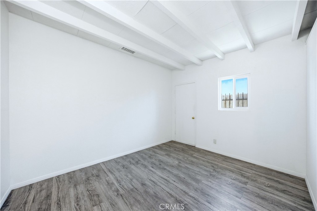 1619 West 163rd Street Compton, CA 90220 - Photo 16 of 36 an empty room with wooden floor and windows