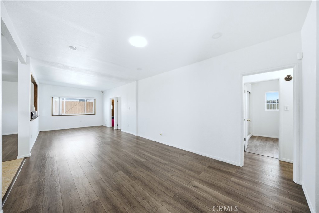 1619 West 163rd Street Compton, CA 90220 - Photo 5 of 36 an empty room with wooden floor and windows