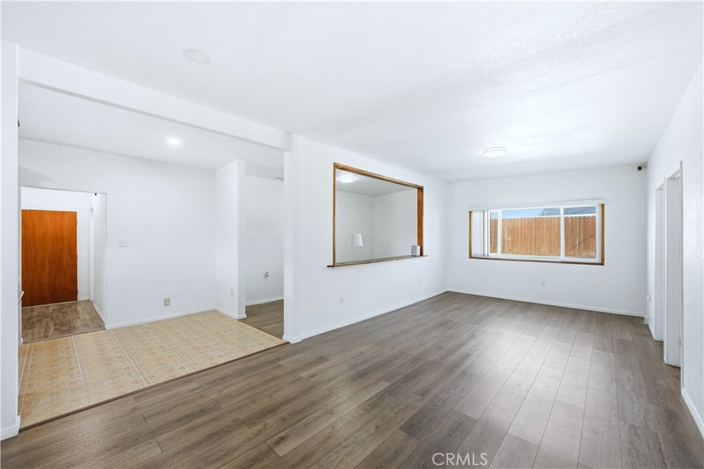 1619 West 163rd Street Compton, CA 90220 - Photo 6 of 36 an empty room with wooden floor and windows