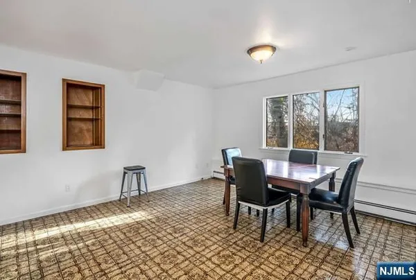 a view of a dining room with furniture and window