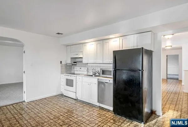 a kitchen with a refrigerator and a sink