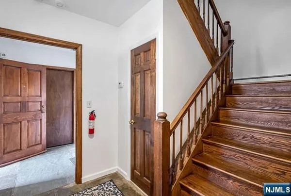 a view of an entryway with wooden floor and stairs