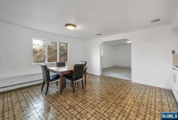 a dining room with furniture and window