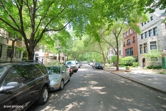 a view of a street with cars parked