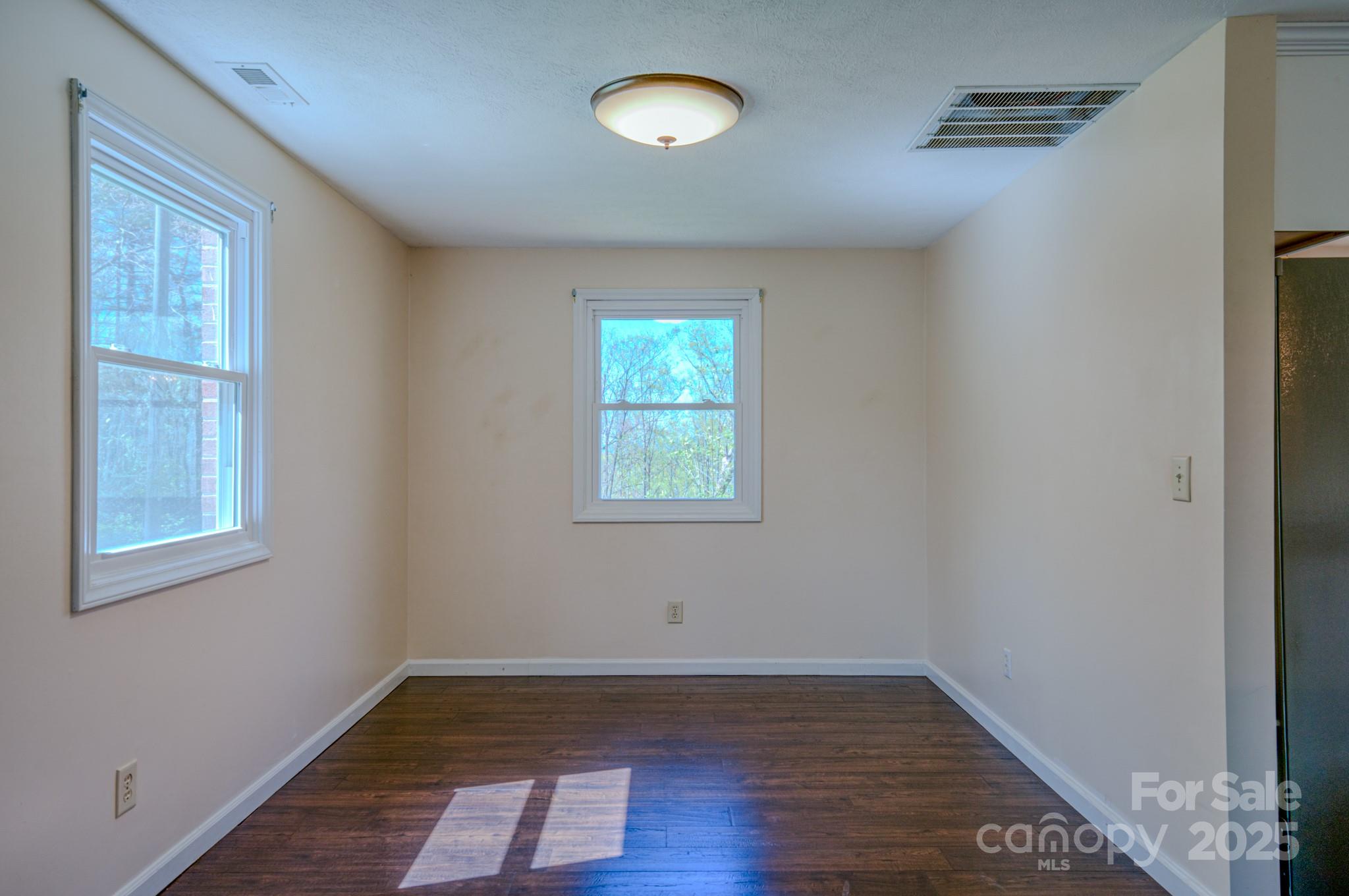 280 Fletcher View Drive Fletcher, NC 28732 - Photo 12 of 40 a view of an empty room with wooden floor and a window