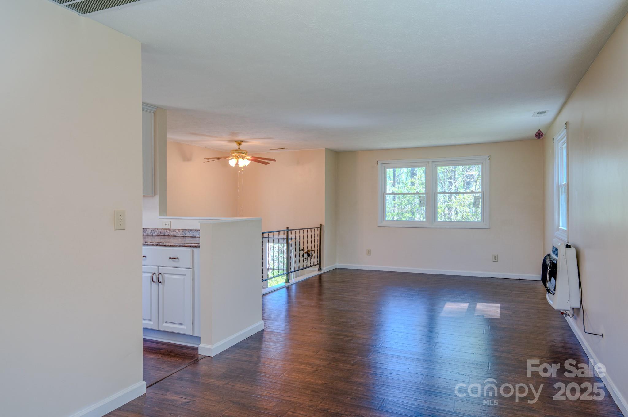 280 Fletcher View Drive Fletcher, NC 28732 - Photo 14 of 40 an empty room with wooden floor cabinet and windows