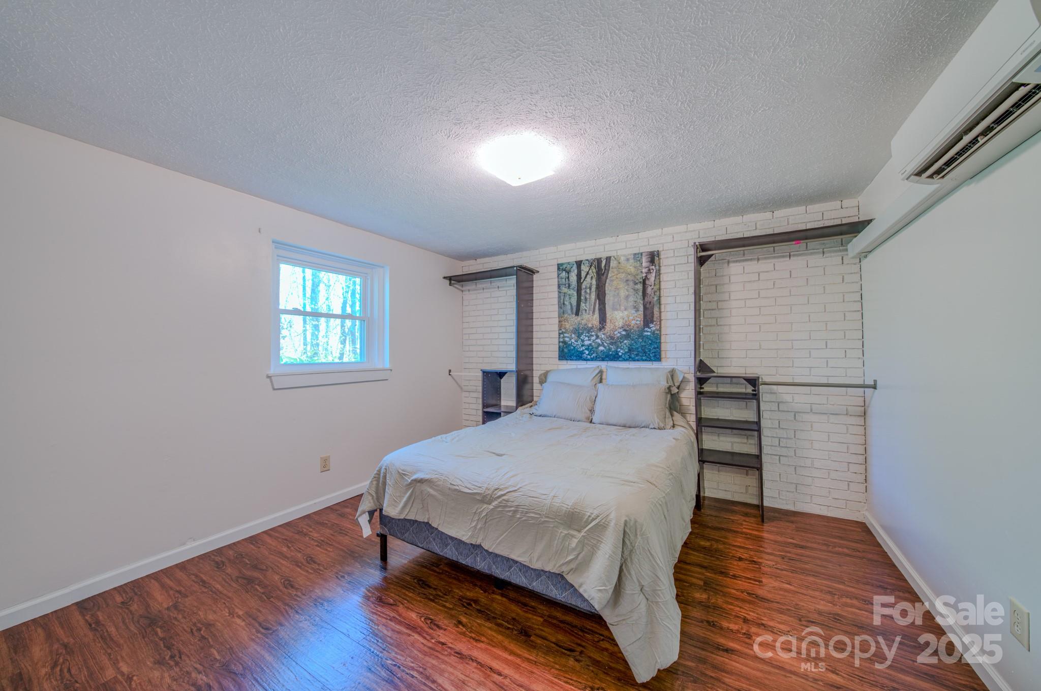 280 Fletcher View Drive Fletcher, NC 28732 - Photo 19 of 40 a bedroom with a bed and wooden floor