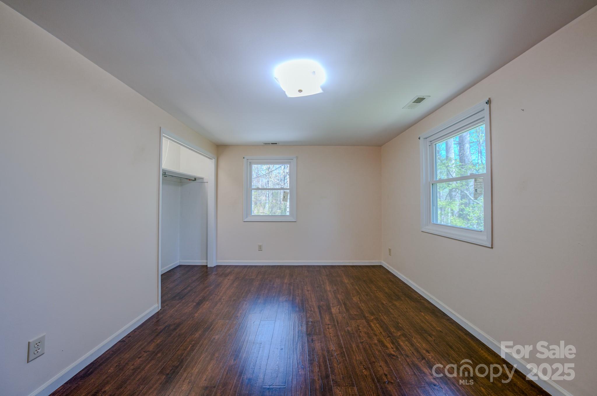 280 Fletcher View Drive Fletcher, NC 28732 - Photo 21 of 40 a view of an empty room with wooden floor and a window